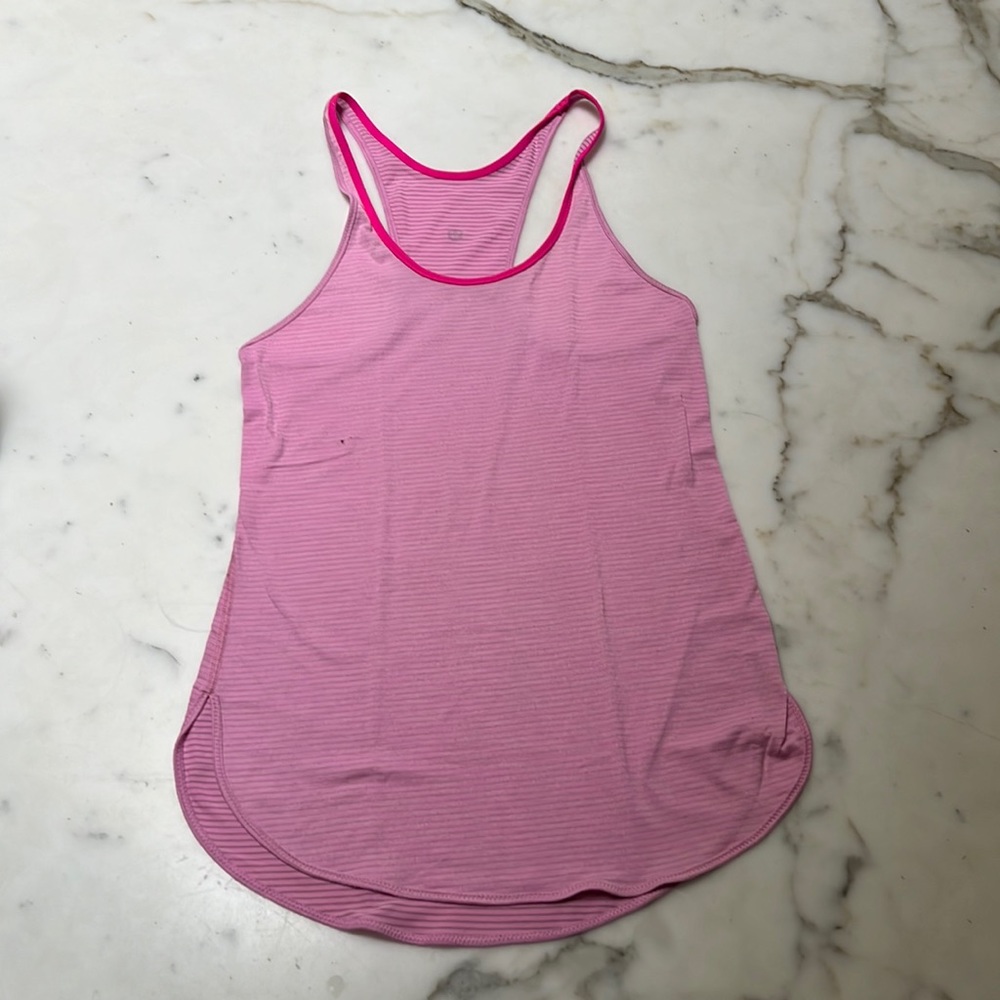 Lululemon rare pink tank super stylish.  One small flaw black mark as shown